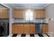 This updated kitchen showcases stainless steel appliances, custom cabinetry, and checkerboard floors at 539 Marsh Rd, Charlotte, NC 28209