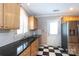 This updated kitchen showcases stainless steel appliances, custom cabinetry, and checkerboard floors at 539 Marsh Rd, Charlotte, NC 28209