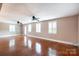 Bright living room with hardwood floors, large windows, and ceiling fans at 539 Marsh Rd, Charlotte, NC 28209