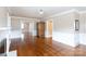 Open living room features hardwood floors, doorway, and vintage cabinet at 539 Marsh Rd, Charlotte, NC 28209
