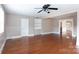 Large living room features hardwood floors, ceiling fan, and open entryway at 539 Marsh Rd, Charlotte, NC 28209