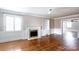 Inviting living room with a fireplace, built-in shelving, and gleaming hardwood floors at 539 Marsh Rd, Charlotte, NC 28209