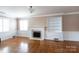Bright living room features hardwood floors, fireplace, and built-in shelving at 539 Marsh Rd, Charlotte, NC 28209