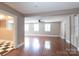 Bright living room with hardwood floors, ceiling fan, and open floor plan at 539 Marsh Rd, Charlotte, NC 28209