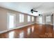 Expansive living room features hardwood floors, multiple windows, and ceiling fans at 539 Marsh Rd, Charlotte, NC 28209