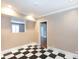 A spacious room with unique checkerboard flooring and neutral wall colors at 539 Marsh Rd, Charlotte, NC 28209