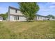 Expansive backyard with mature tree offers ample space for outdoor enjoyment and privacy at 6135 Raisin Tree Ln, Charlotte, NC 28215