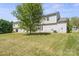A sprawling backyard and mature tree provide a peaceful outdoor retreat at 6135 Raisin Tree Ln, Charlotte, NC 28215