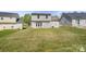 Spacious backyard featuring a well-maintained lawn and patio area, great for outdoor activities at 6135 Raisin Tree Ln, Charlotte, NC 28215