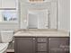 Well-lit bathroom featuring granite countertops, vanity, and an open view through the mirror at 6135 Raisin Tree Ln, Charlotte, NC 28215