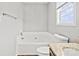 Bright bathroom with a large soaking tub, granite countertop vanity, and a window at 6135 Raisin Tree Ln, Charlotte, NC 28215