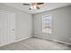 Neutral bedroom featuring gray walls and carpet, complemented by a single window at 6135 Raisin Tree Ln, Charlotte, NC 28215