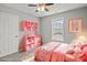 Charming bedroom with pink decor, including a bed, shelves, and a window at 6135 Raisin Tree Ln, Charlotte, NC 28215