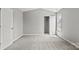 Bright bedroom with plush carpet, a closet, and a view of the neighborhood at 6135 Raisin Tree Ln, Charlotte, NC 28215