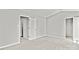 Spacious bedroom with a walk-in closet, ensuite bathroom, and plush carpet at 6135 Raisin Tree Ln, Charlotte, NC 28215