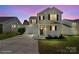 Beautiful two-story home with red shutters and a covered porch, captured against a vibrant twilight sky at 6135 Raisin Tree Ln, Charlotte, NC 28215