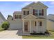 Charming two-story home featuring red shutters, a covered porch, and a two-car garage at 6135 Raisin Tree Ln, Charlotte, NC 28215