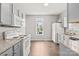 Bright kitchen with granite counters, white appliances, and ample cabinet space at 6135 Raisin Tree Ln, Charlotte, NC 28215