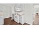 Cozy kitchen showcases granite counters and white appliances including stove and microwave at 6135 Raisin Tree Ln, Charlotte, NC 28215