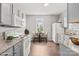 Charming kitchen with granite countertops, white appliances, and a breakfast nook at 6135 Raisin Tree Ln, Charlotte, NC 28215