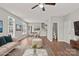 Open-concept living area featuring hardwood floors, a dining area, and staircase to upper level at 6135 Raisin Tree Ln, Charlotte, NC 28215