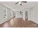 Open living room showcasing hardwood floors, a staircase, and access to a half bathroom at 6135 Raisin Tree Ln, Charlotte, NC 28215