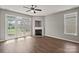 Bright and airy living room with fireplace, hardwood floors, and large windows overlooking the yard at 6135 Raisin Tree Ln, Charlotte, NC 28215