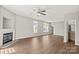 Well-lit living room boasts hardwood floors, a fireplace, and adjacent bathroom at 6135 Raisin Tree Ln, Charlotte, NC 28215