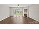 Bright living room featuring a fireplace and French doors leading to the backyard at 6135 Raisin Tree Ln, Charlotte, NC 28215
