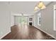 Bright and airy living room featuring a fireplace, hardwood floors, and french doors leading to the backyard at 6135 Raisin Tree Ln, Charlotte, NC 28215