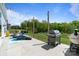 Spacious backyard with lounge chairs, patio seating, string lights, and a modern gas grill at 6145 Holland St, Fort Mill, SC 29707