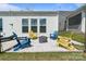 Cozy backyard features Adirondack chairs around a modern fire pit, perfect for outdoor relaxation at 6145 Holland St, Fort Mill, SC 29707