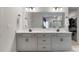 Bathroom with a double vanity and undermount sinks and open walk-in closet at 6145 Holland St, Fort Mill, SC 29707