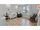 Cozy Bedroom with a white crib, rocking chair, and soft natural light creates a peaceful and inviting atmosphere at 6145 Holland St, Fort Mill, SC 29707