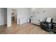 Bright Bedroom featuring a crib, changing table, and cozy armchair, creating a serene and functional space at 6145 Holland St, Fort Mill, SC 29707