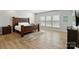 Spacious bedroom with hardwood floors, large windows, and a wooden bedframe at 6145 Holland St, Fort Mill, SC 29707
