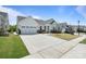 Charming two-story home with a spacious driveway, a well-manicured lawn, and a two-car garage at 6145 Holland St, Fort Mill, SC 29707