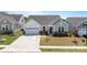 Attractive single-Gathering home with a two-car garage, manicured lawn, and inviting front entrance at 6145 Holland St, Fort Mill, SC 29707