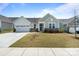 Charming single-story home featuring a well-manicured lawn, stone accents and an attached two-car garage at 6145 Holland St, Fort Mill, SC 29707