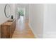 Bright hallway featuring wood floors that lead to the living area with natural light and stylish decor at 6145 Holland St, Fort Mill, SC 29707
