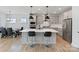 Stylish open kitchen featuring a large island with seating, stainless steel appliances, and modern pendant lighting at 6145 Holland St, Fort Mill, SC 29707