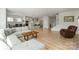 Spacious open-concept living area flowing into the kitchen, featuring a comfortable sofa and hardwood flooring at 6145 Holland St, Fort Mill, SC 29707