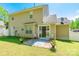 Backyard patio with sliding glass doors, chairs, and lush green surroundings at 6622 Cedar Cliff Dr, Charlotte, NC 28216