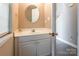Cozy half bathroom featuring a round mirror, and white cabinets at 6622 Cedar Cliff Dr, Charlotte, NC 28216