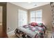 Cozy bedroom with neutral walls, plush carpeting, and a bright window at 6622 Cedar Cliff Dr, Charlotte, NC 28216