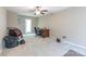 Spacious room showcasing a ceiling fan, desk, chair, and back door, offering comfort and functionality at 6622 Cedar Cliff Dr, Charlotte, NC 28216