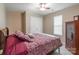 A relaxing bedroom with a ceiling fan, neutral walls, and a comfortable-looking patterned bed at 6622 Cedar Cliff Dr, Charlotte, NC 28216