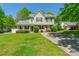 Charming two-story home featuring a welcoming front porch and beautiful landscaping at 6622 Cedar Cliff Dr, Charlotte, NC 28216