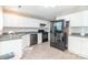 Functional kitchen features white cabinets and black appliances at 6622 Cedar Cliff Dr, Charlotte, NC 28216