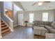 Open living room with soaring ceilings, neutral paint, and gray wood-look floors at 6622 Cedar Cliff Dr, Charlotte, NC 28216